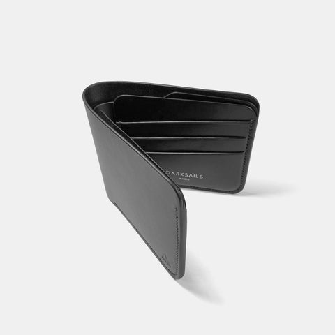Black leather bifold wallet open showing interior card slots and compartments