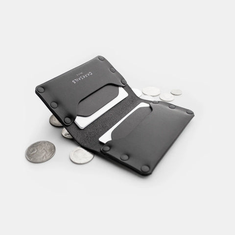 Porte-cartes cuir noir ouvert avec tirette, cartes et pièces