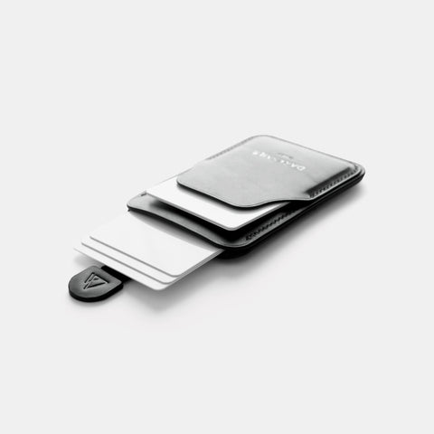 Black leather card holder showing pull tab extended with cards visible