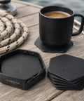Dessous de verre cuir noir hexagonal avec tasse à café sur bois