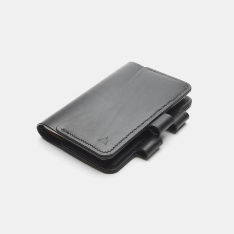 Handmade black leather notebook cover closed with pen loop detail