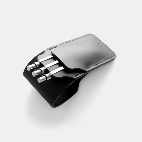 Black leather pen case closed showing tuck flap and saddle stitch detail