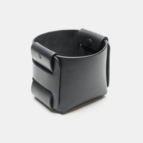 Panier de rangement en cuir noir vu de trois quarts, avec construction pliée et emboîtée