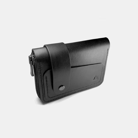 Black leather wallet with wrist strap showing compact profile