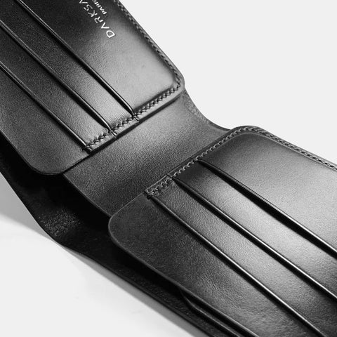 Handmade leather wallet close-up showing saddle stitch craftsmanship detail