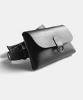 Leather belt bag open showing interior compartment and snap closure