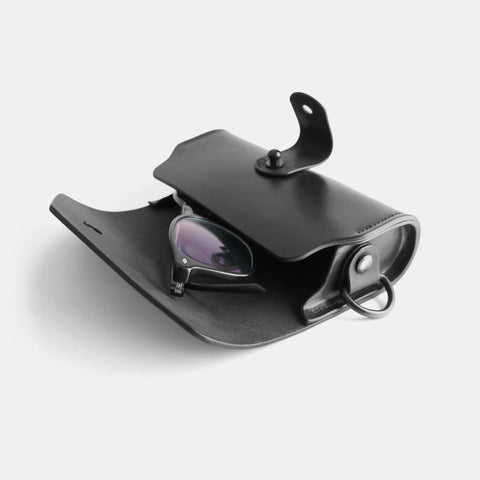 Leather glasses case open showing interior lining and protective design