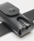 Black leather multitool holster belt loop and snap closure close-up
