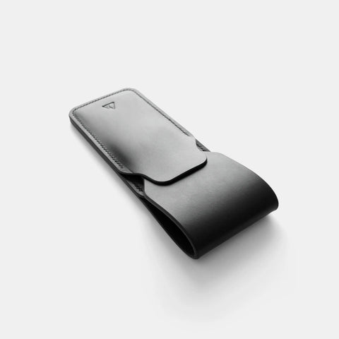 Leather pen case in use with hand accessing three pens