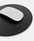 Round leather mousepad in black showing smooth surface for mouse tracking