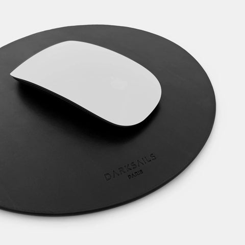 Round leather mousepad in black showing smooth surface for mouse tracking